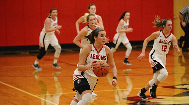 Tecumseh senior Corinne Thomas (center) leads an Arrows’ fastbreak with senior Mackenzie Pauley (12) and senior Presley Griffitts (behind Thomas) trailing the play. Greg Billing / Contributed