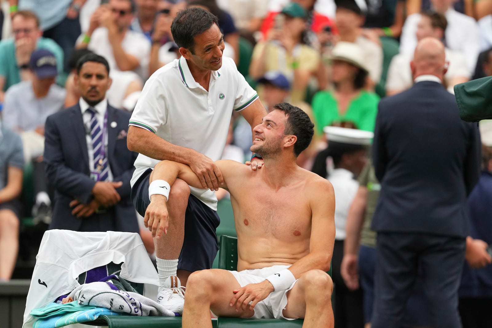 Pedro Martinez of Spain receives treatment during a medical timeout as he plays Jannik Sinner of Italy during a third round men's singles match at the Wimbledon Tennis Championships in London, Saturday, July 5, 2025. (AP Photo/Kirsty Wigglesworth)
