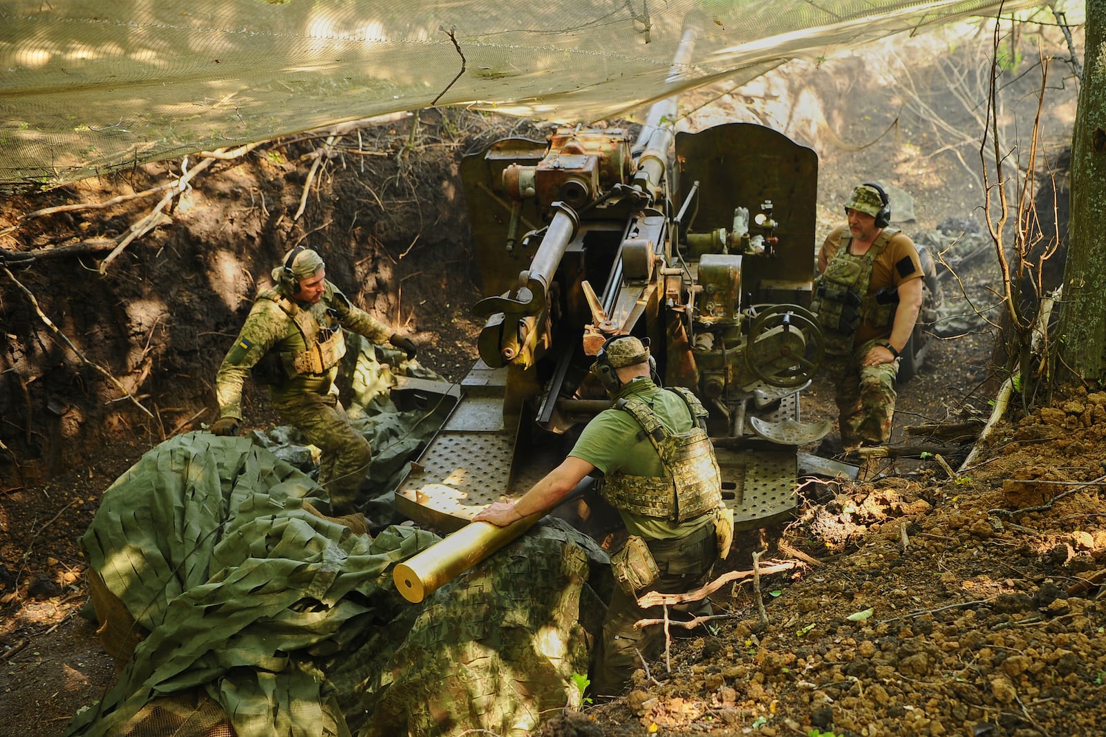 In this photo provided by Ukraine's 127th Separate Brigade of the Territorial Defence press service, soldiers fire a canon towards Russian army positions near Kharkiv, Ukraine, Monday, June 2, 2025, (Anatolii Lysianskyi/Ukraine's 127th Separate Brigade via AP)