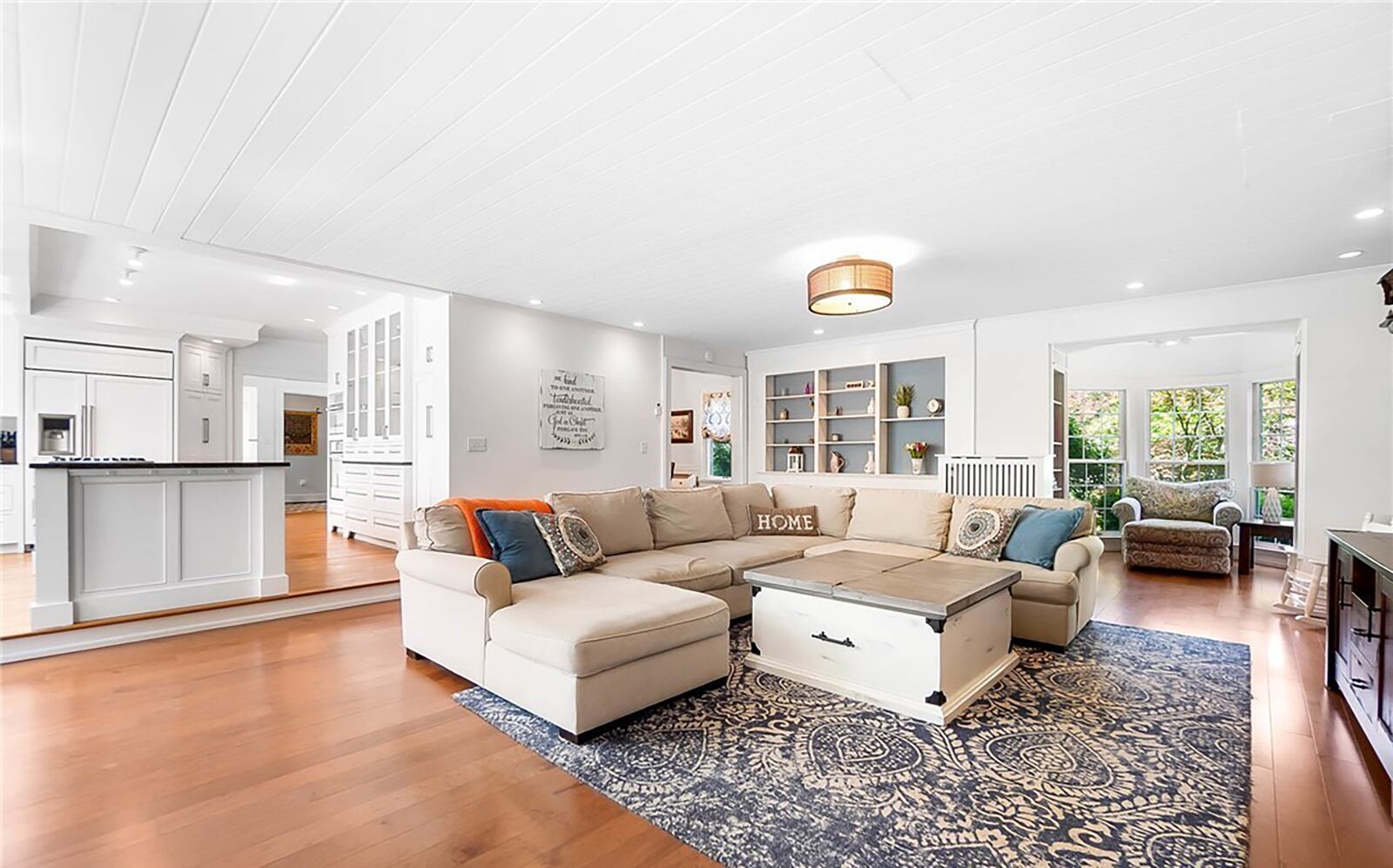 The family room has hardwood flooring and a newer gas fireplace and is open to the kitchen.
