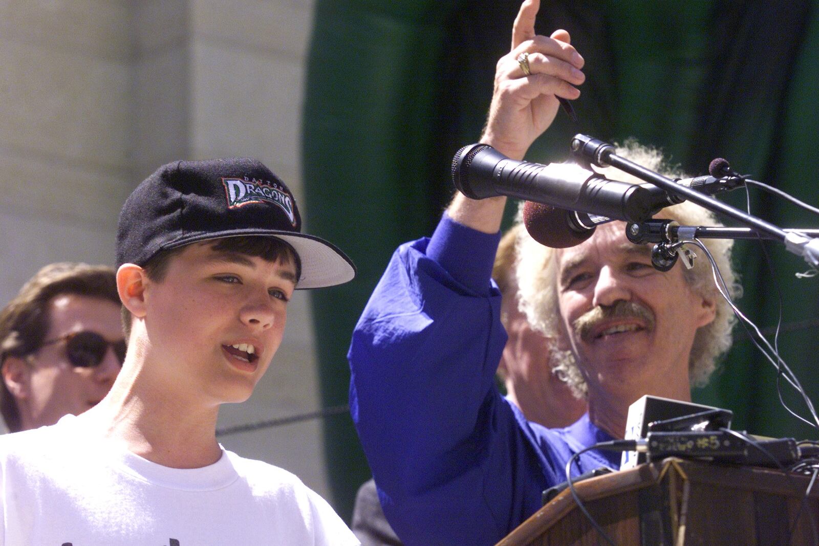 Dayton Daily News columnist, Dale Huffman, right, sings Take Me Out to the Ball Game with Richard Burque, of Huber Heights, the winner of the name the Dayton baseball team contest. The Dayton professional baseball team's logo and name were revealed at Courthouse Square. DAYTON DAILY NEWS ARCHIVES