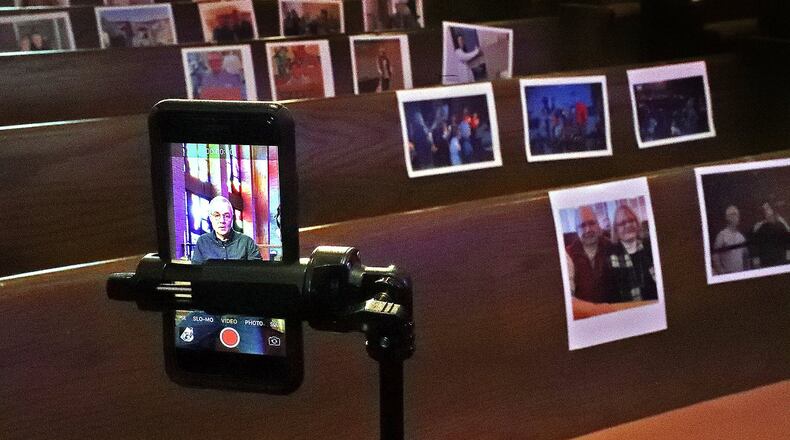 Due to the caronavirus, Carl Ruby, senior pastor at the Central Christian Church in Springfield, has to record his church services with his cell phone so his parishioners can watch them online. He mentioned to the church secretary that it was hard to preach to an empty church so she printed pictures of the parishioners and taped them to the pews. BILL LACKEY/STAFF