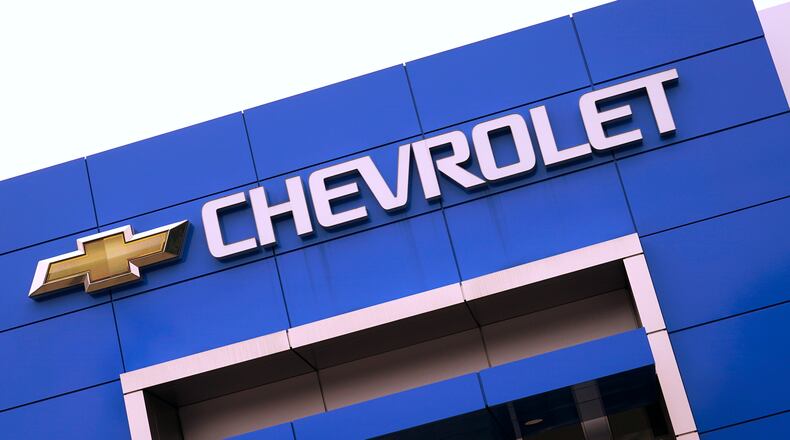 The Chevrolet logo is displayed on the facade of a dealership , Tuesday, Aug. 3, 2021, in Woburn, Mass. Despite a computer chip shortage that temporarily closed some of its factories, General Motors made a healthy $2.8 billion second-quarter net profit in the second quarter.  (AP Photo/Charles Krupa)