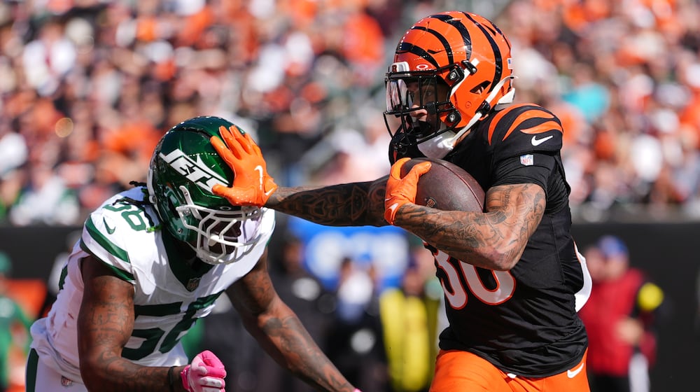 Cincinnati Bengals running back Chase Brown (30) is chased by New York Jets linebacker Quincy Williams (56) during the first half of an NFL football game, Sunday, Oct. 26, 2025, in Cincinnati. (AP Photo/Joshua A. Bickel)