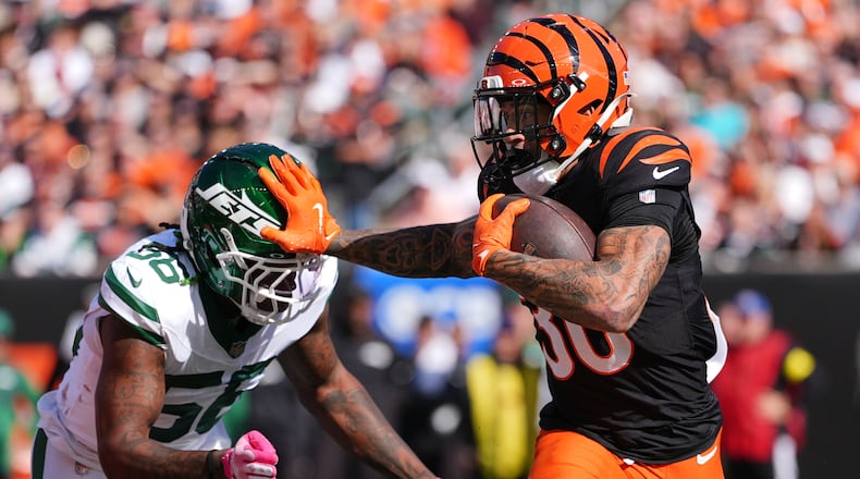 Cincinnati Bengals running back Chase Brown (30) is chased by New York Jets linebacker Quincy Williams (56) during the first half of an NFL football game, Sunday, Oct. 26, 2025, in Cincinnati. (AP Photo/Joshua A. Bickel)