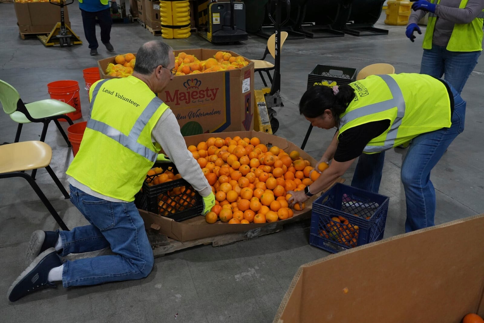 Volunteers pack produce at the Alameda County Community Food Bank in Alameda, Calif., on Friday, April 25, 2025. (AP Photo/Terry Chea)