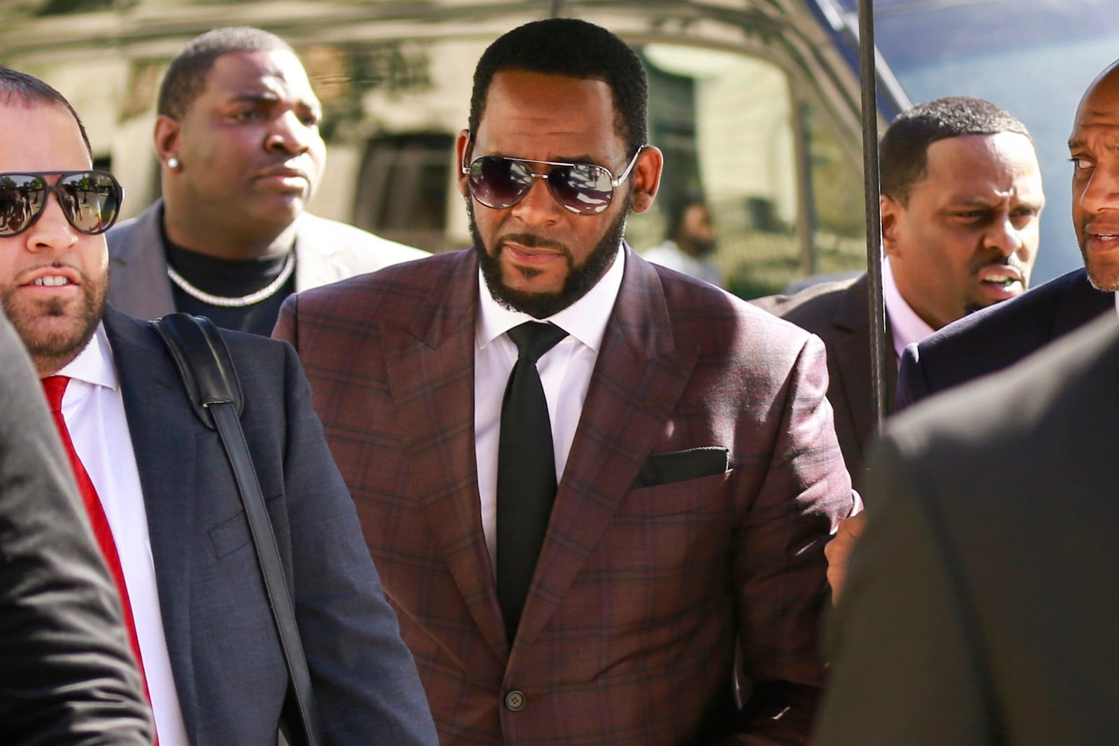 FILE - R&B singer R. Kelly, center, arrives at the Leighton Criminal Court building for an arraignment on sex-related felonies in Chicago, June 26, 2019. (AP Photo/Amr Alfiky, File)