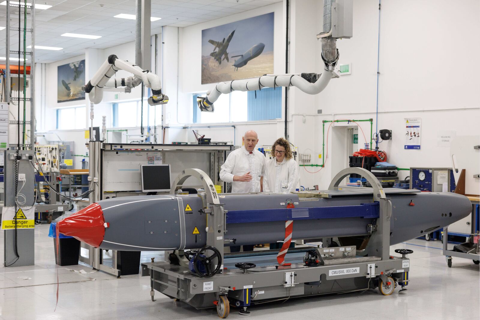 Louise Holmes, MBDA UK Deputy Managing Director, shows Britain's Defence Secretary John Healey, left, a storm shadow missile on an assembly line at the MBDA Storm Shadow factory in Stevenage, England, Saturday May 31, 2025. (Dan Kitwood/Pool via AP)
