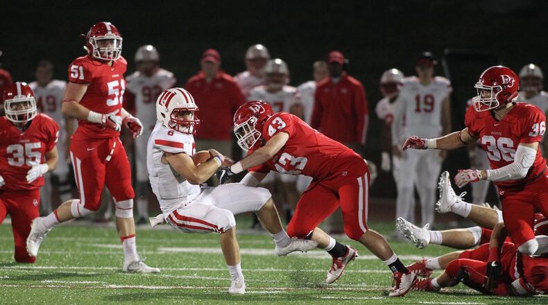 Wittenberg’s Jake Kennedy takes a hit from Denison’s Hayden Hatten in the first half at Deeds Field on Saturday, Oct. 15, 2016, in Granville. David Jablonski/Staff