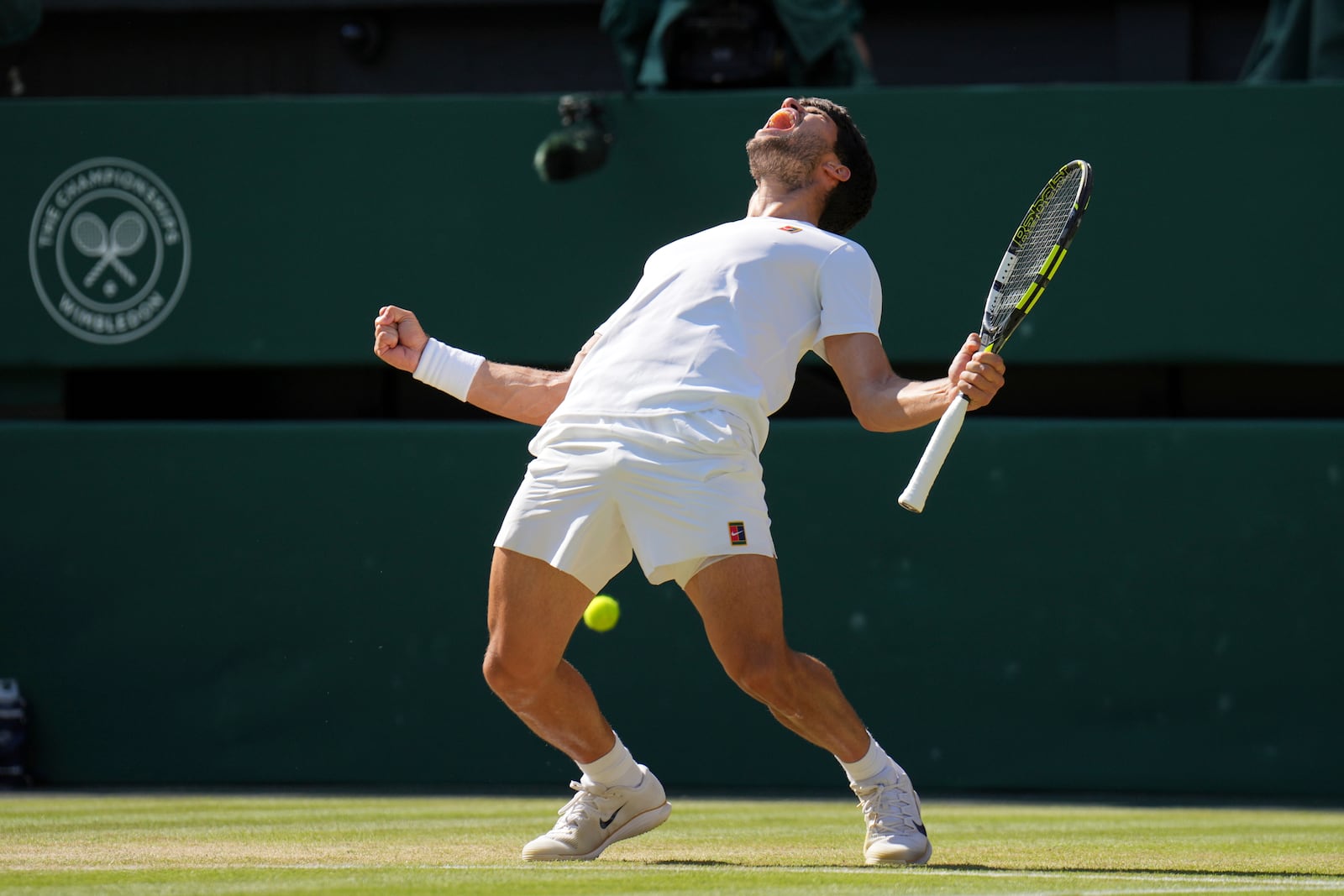 Spain's Carlos Alcaraz celebrates after beating Taylor Fritz of the U.S. in a men's singles semifinal at the Wimbledon Tennis Championships in London, Friday, July 11, 2025. (AP Photo/Kin Cheung)