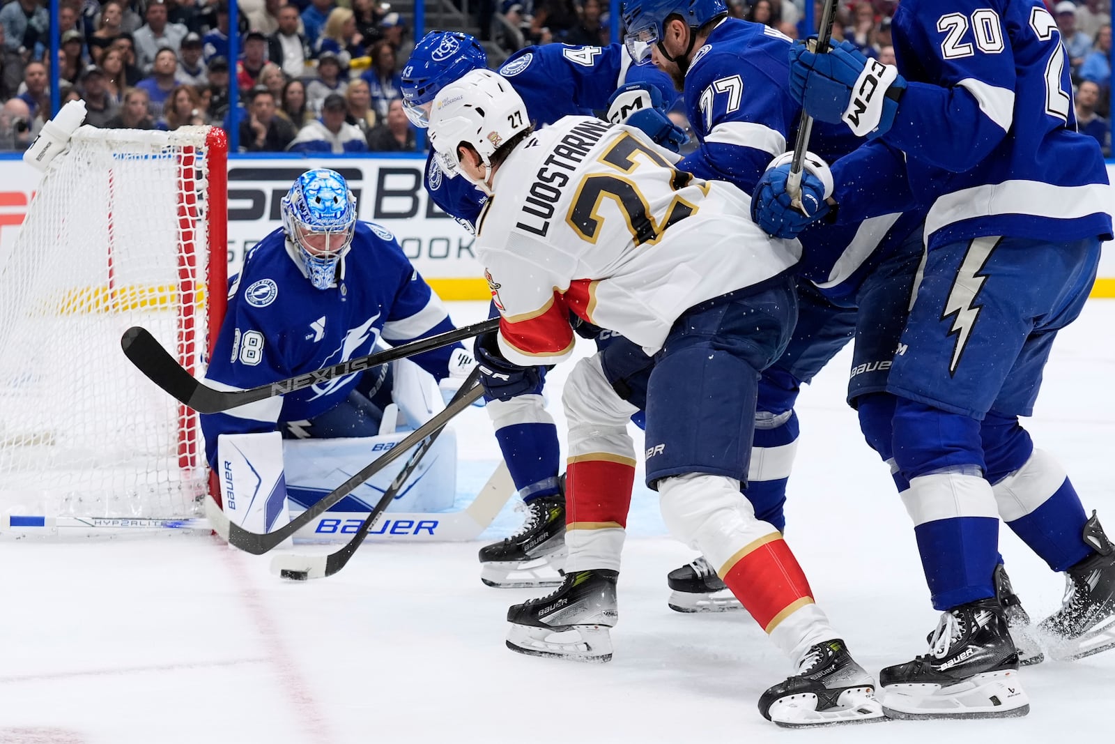 Tampa Bay Lightning goaltender Andrei Vasilevskiy (88) stops a shot by Florida Panthers center Eetu Luostarinen (27) during the first period in Game 1 of an NHL hockey Stanley Cup first-round playoff series, Tuesday, April 22, 2025, in Tampa, Fla. (AP Photo/Chris O'Meara)
