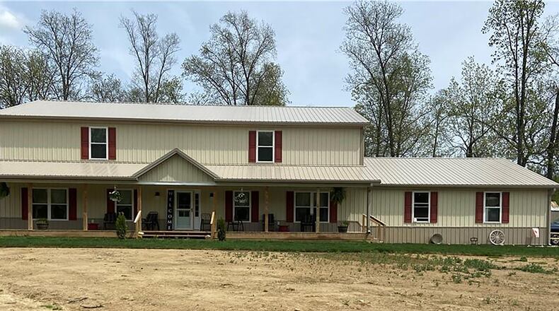 A long driveway leads to the side-entry, 3-car garage of the 5-bedroom home with covered front porch. The 2-story offers about 3,650 sq. ft. of living space and includes a first-floor main bedroom suite. CONTRIBUTED PHOTO