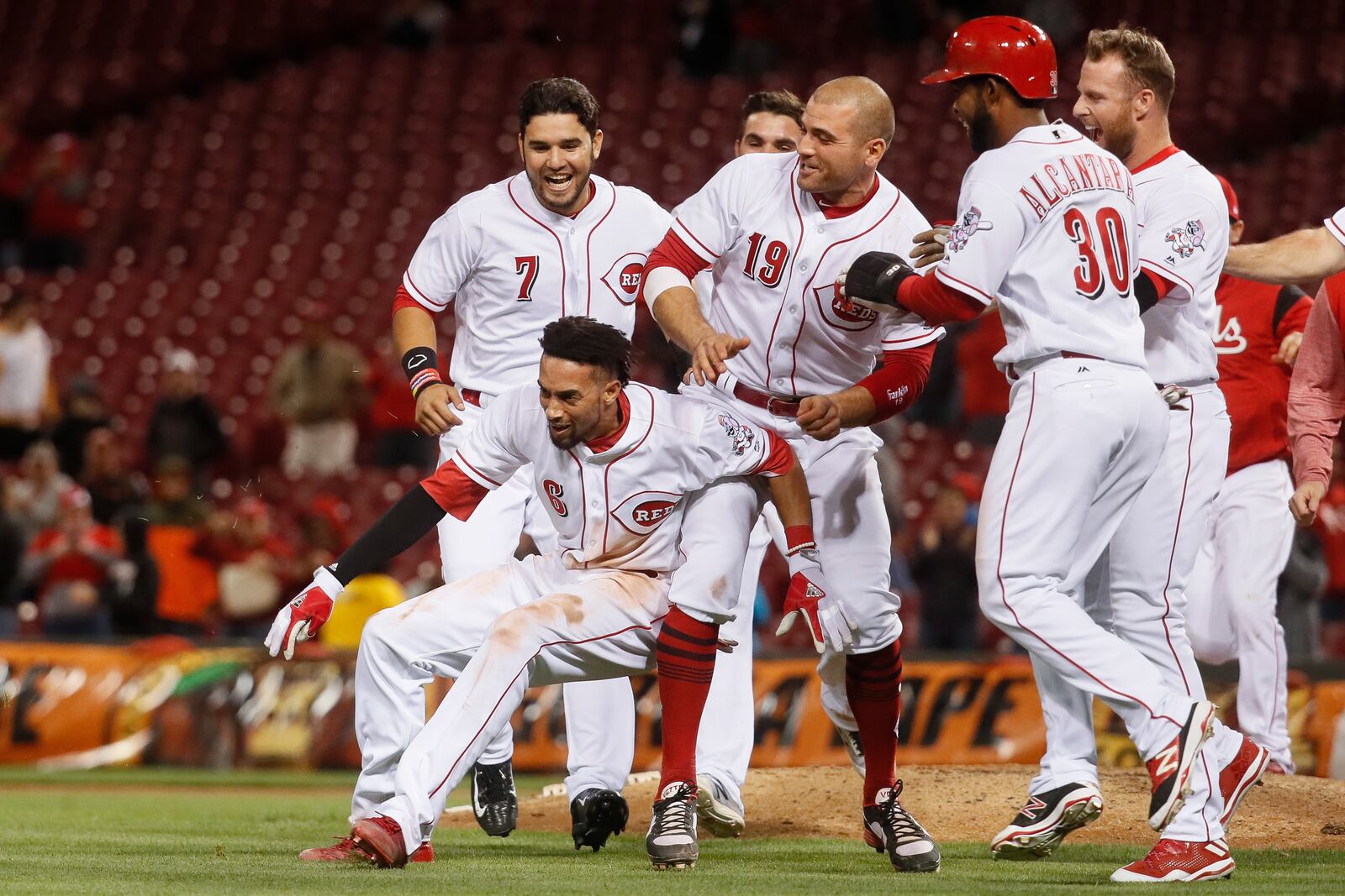 Cincinnati Reds’ Billy Hamilton (6) celebrates with Joey Votto (19) after hitting the game-winning RBI single in the 10th inning of a baseball game, Monday, May 1, 2017, in Cincinnati. The Reds won 4-3. (AP Photo/John Minchillo)