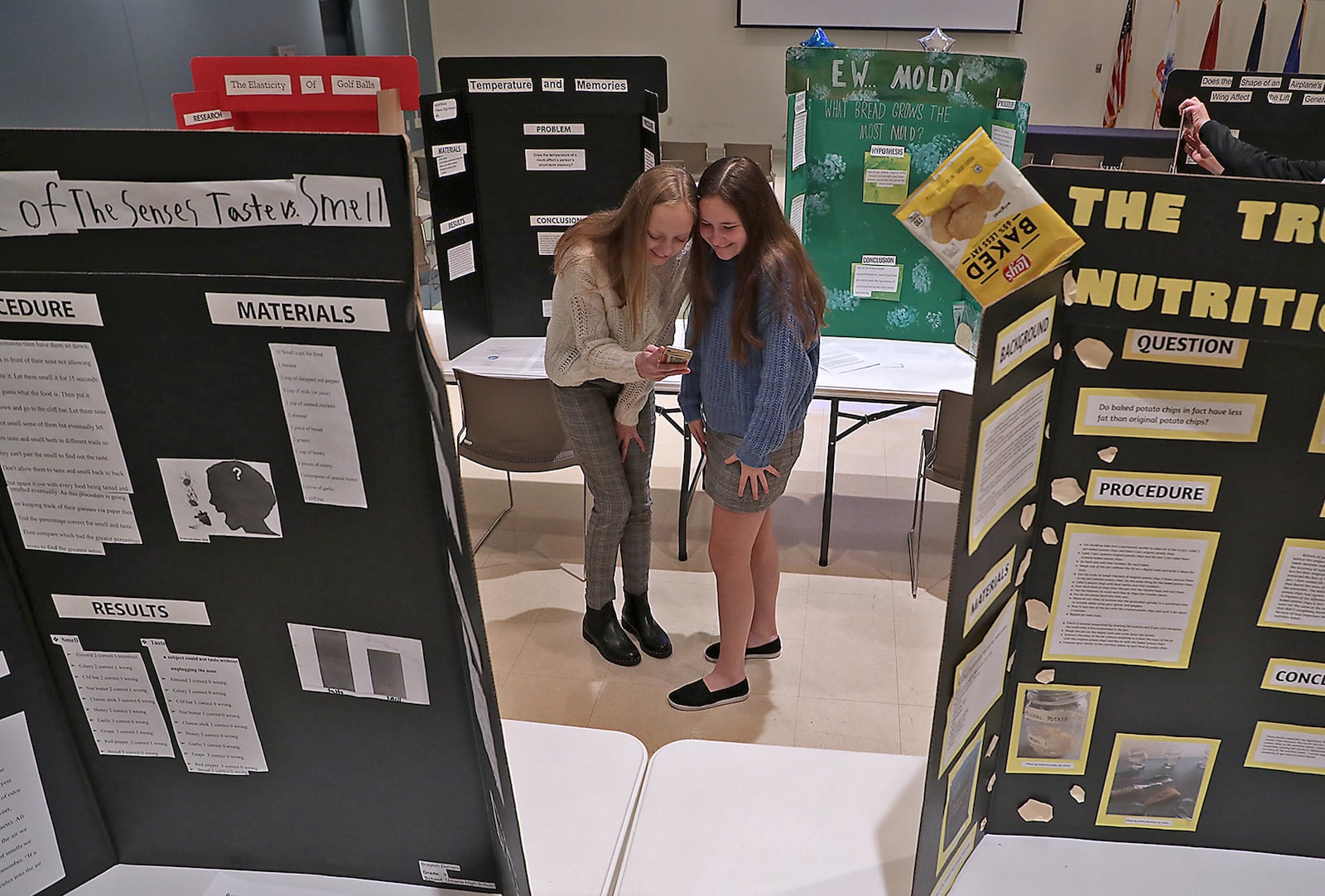 Kayla Booze, 14, left, and Brynna Burnside, 14, both from Urbana City Schools, take a selfie before the start of the Champaign County Science Day at Urbana University Thursday. Science Day brings kids from Champaign County schools together to compete in a science fair to see who represents the county in the district science fair in March at Edison State College. BILL LACKEY/STAFF