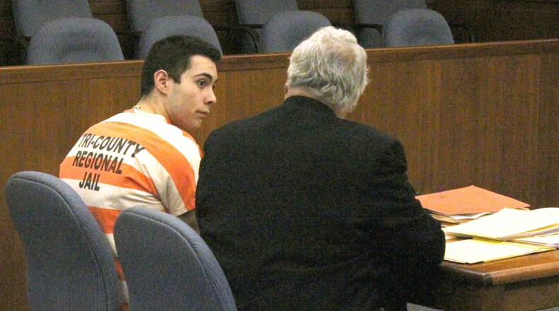 Ely Serna and his attorney Dennis Lieberman talk before a hearing in Champaign County Common Pleas Court. JEFF GUERINI/STAFF