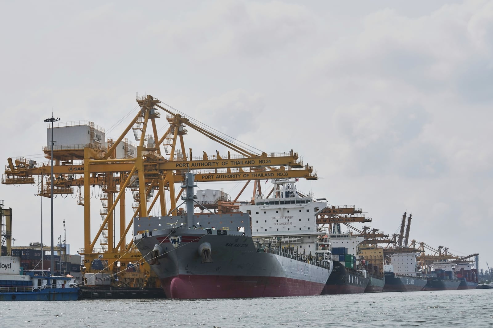 Cranes work on stacks of containers at Bangkok Port in Bangkok, Thailand, Wednesday, April 9, 2025. (AP Photo/Sakchai Lalit)