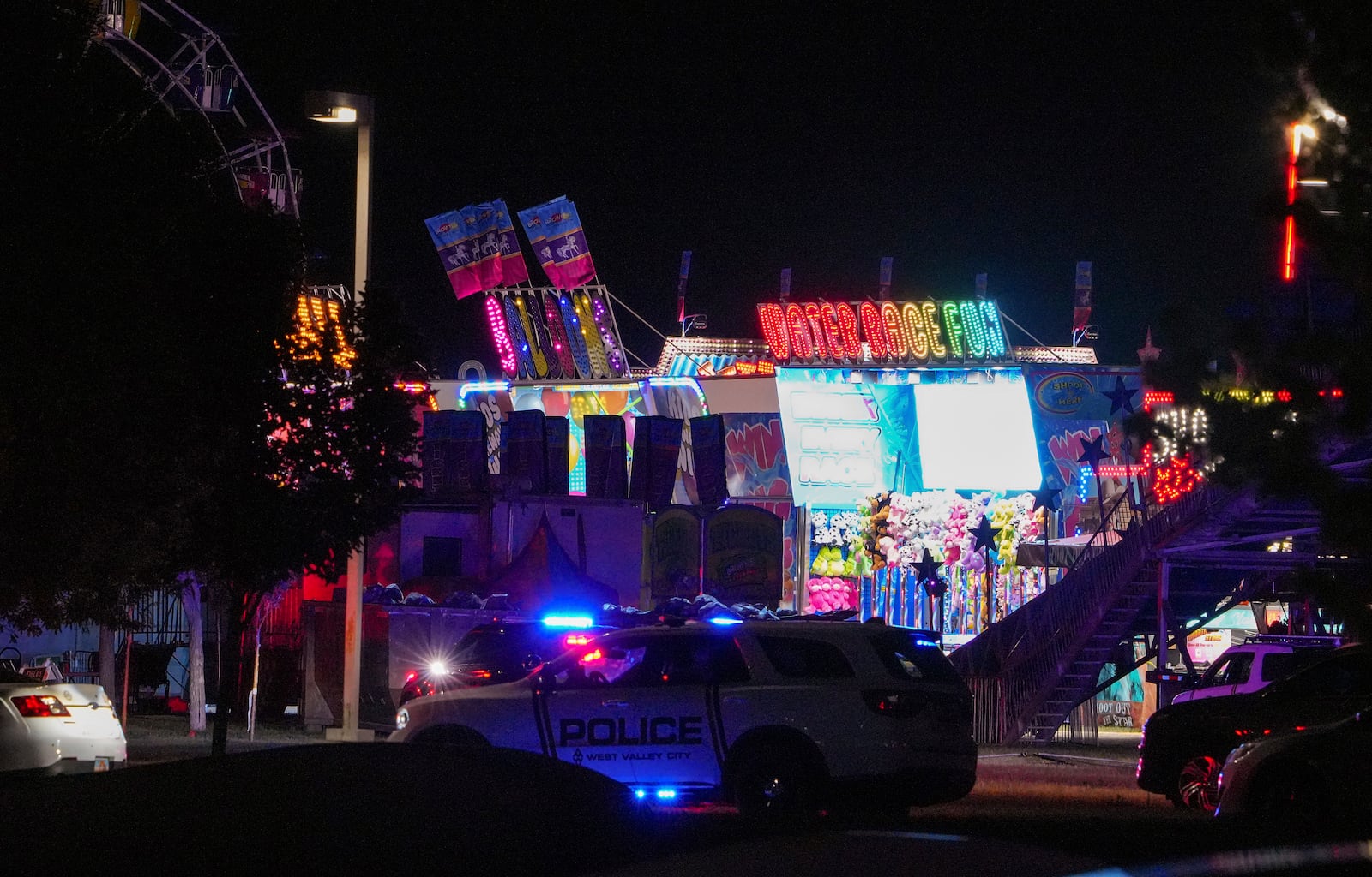 Law enforcement investigate after a reported shooting at WestFest in West Valley City, Utah, June 15, 2025. (Chris Samuels/The Salt Lake Tribune via AP) **NOT AN AP MEMBER**