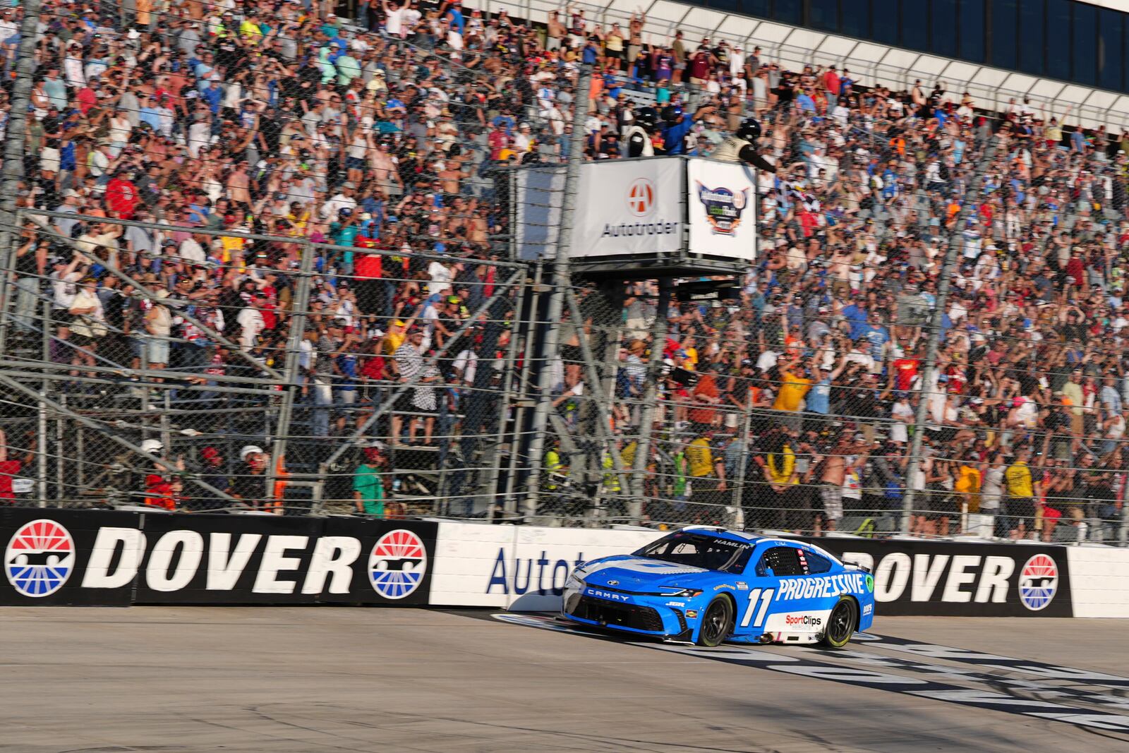 Denny Hamlin crosses the finish line to win a NASCAR Cup Series auto race at Dover Motor Speedway, Sunday, July 20, 2025, in Dover, Del. (AP Photo/Derik Hamilton)