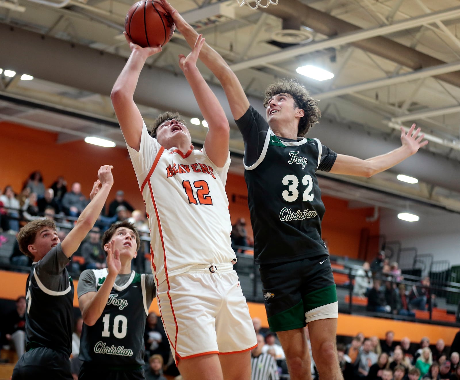 Troy Christian senior Riston Taylor (32) blocks a shot attempt by Beavercreek junior Dawson Paulus (12) in the final seconds of a 54-53 win at Beavercreek in non-league play Tue., Dec. 2, 2025. STEVEN WRIGHT / STAFF