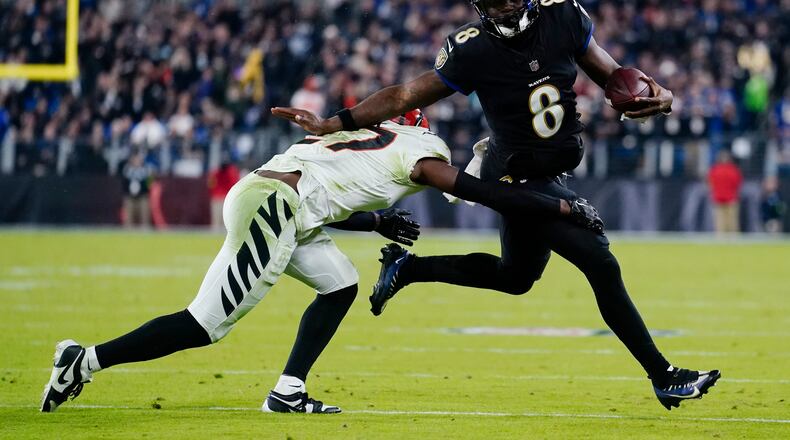 Cincinnati Bengals safety Jordan Battle (27) tackles Baltimore Ravens quarterback Lamar Jackson (8) in the second half of an NFL football game in Baltimore, Thursday, Nov. 16, 2023. (AP Photo/Matt Rourke)