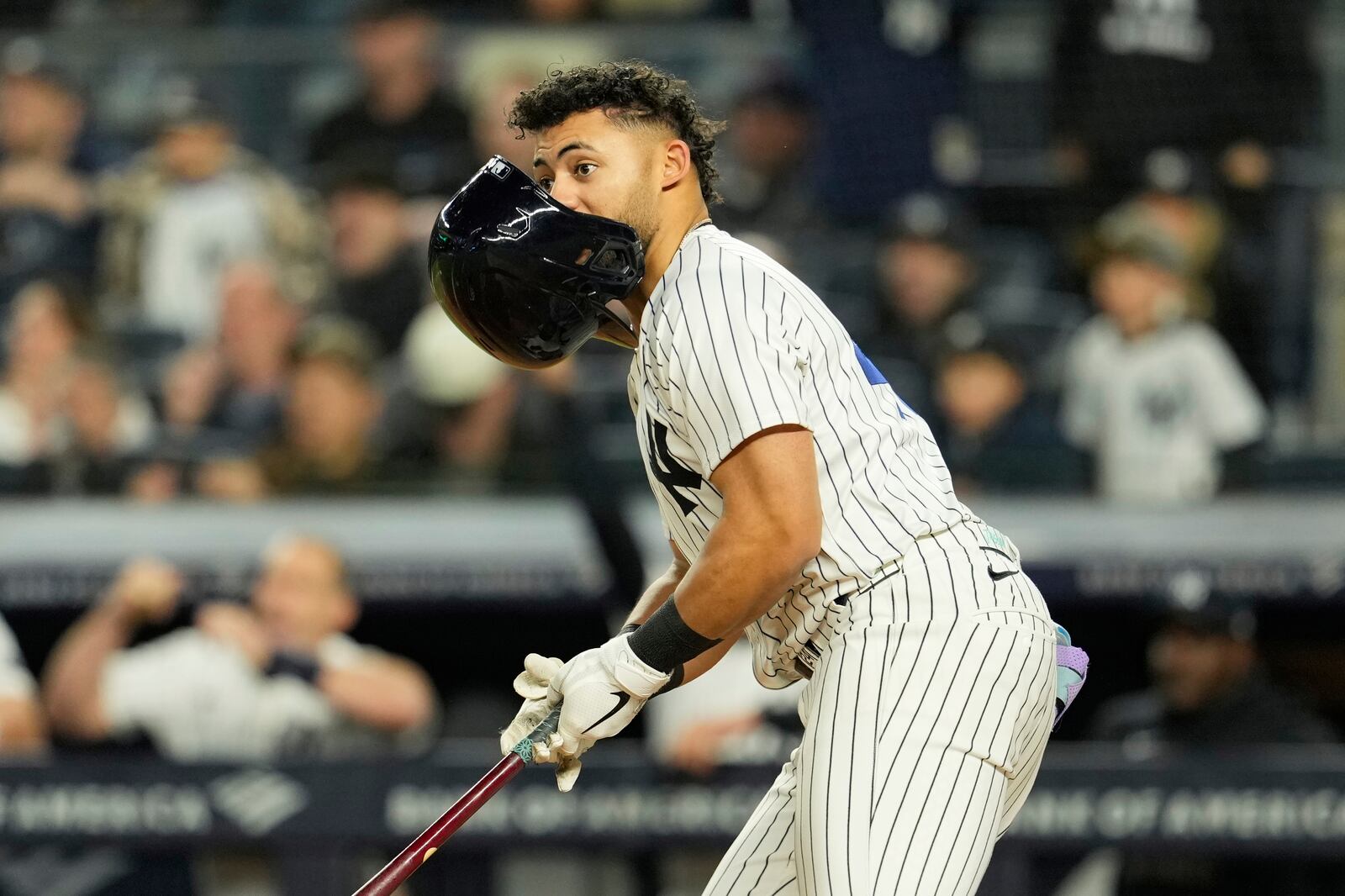 New York Yankees' Jasson Domínguez helmet falls off as he hits a three-run double during the sixth inning of a baseball game Kansas City Royals Tuesday, April 15, 2025, in New York. All the players are wearing 42 in honor of Jackie Robinson Day. (AP Photo/Seth Wenig)