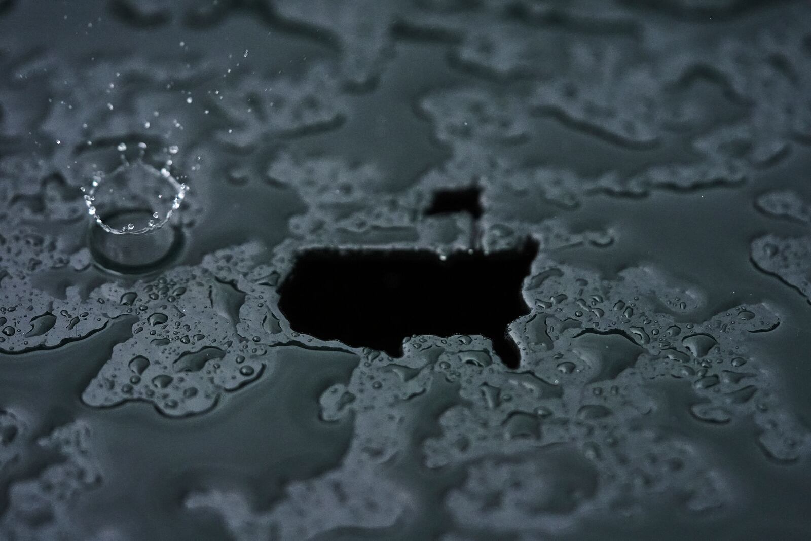 A rain droplet falls on a Masters logo cut out during a practice round at the Masters golf tournament, Monday, April 7, 2025, in Augusta, Ga. (AP Photo/Matt Slocum)