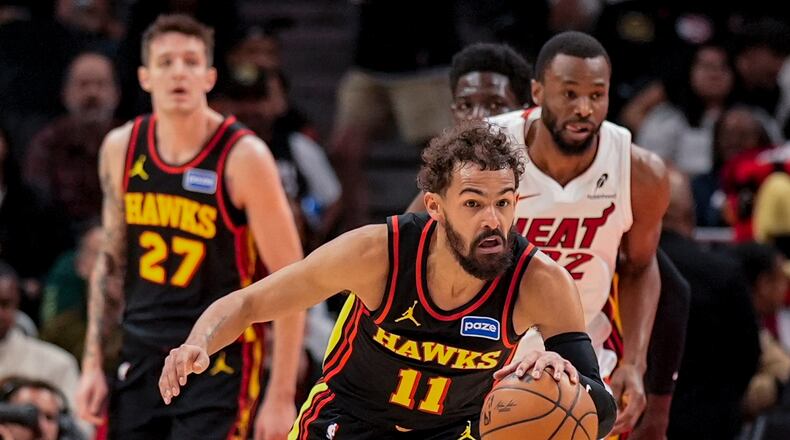 Atlanta Hawks guard Trae Young (11) drives against the Miami Heat during the first half of an NBA basketball game, Friday, Dec. 26, 2025, in Atlanta. (AP Photo/Mike Stewart)