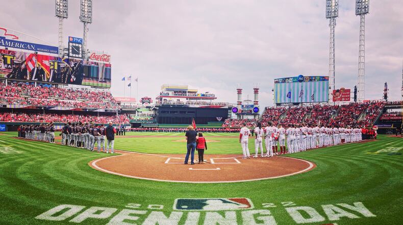 The Reds and Guardians stand for the national anthem on Opening Day on Tuesday, April 12, 2022, at Great American Ball Park in Cincinnati. David Jablonski/Staff