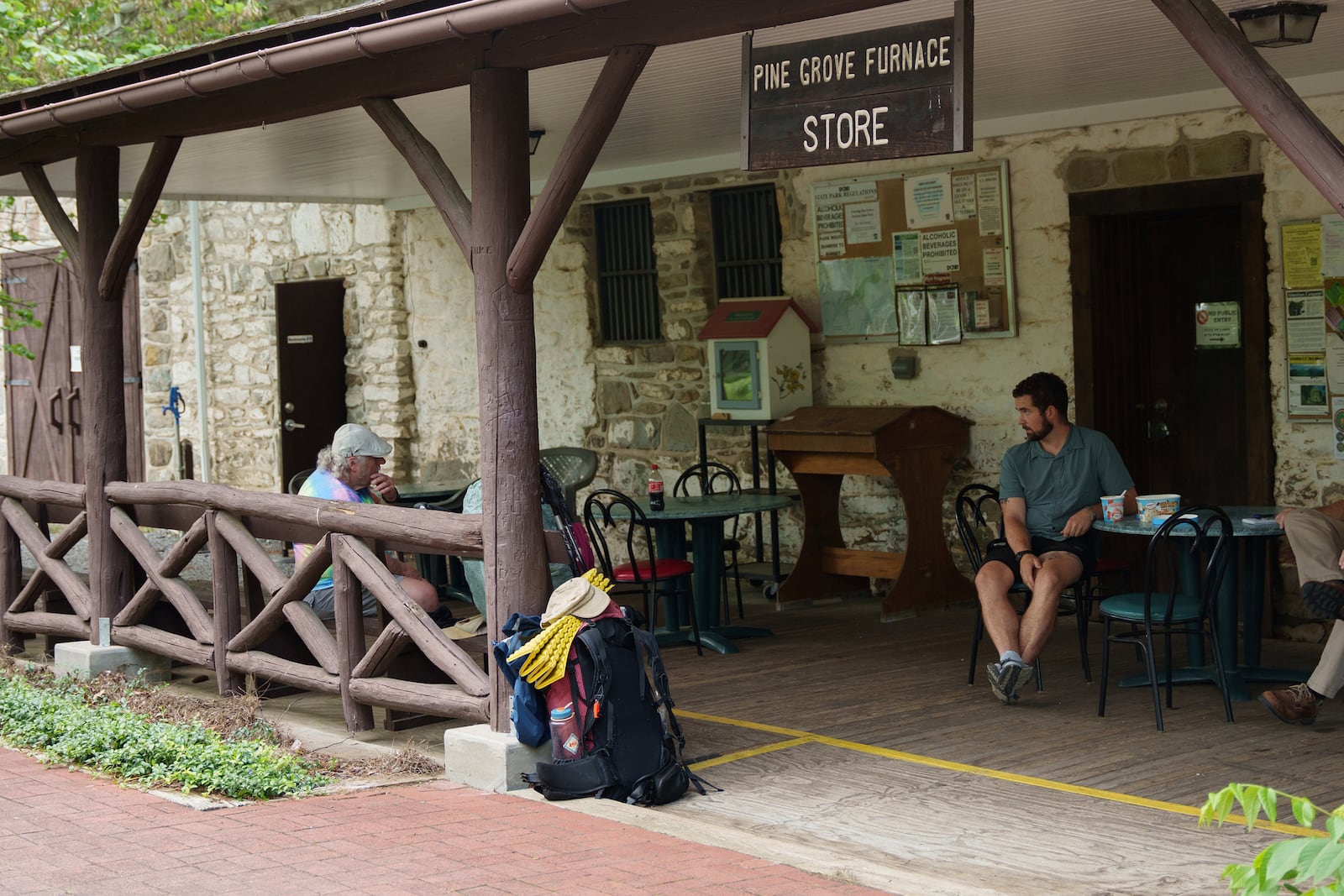 Appalachian Trail thru-hiker Zeke Meddock, trail name Petroglyph, attempts the half-gallon ice cream challenge at Pine Grove Furnace State Park in Pennsylvania on Tuesday, June 10, 2025. (AP Photo/Mingson Lau)