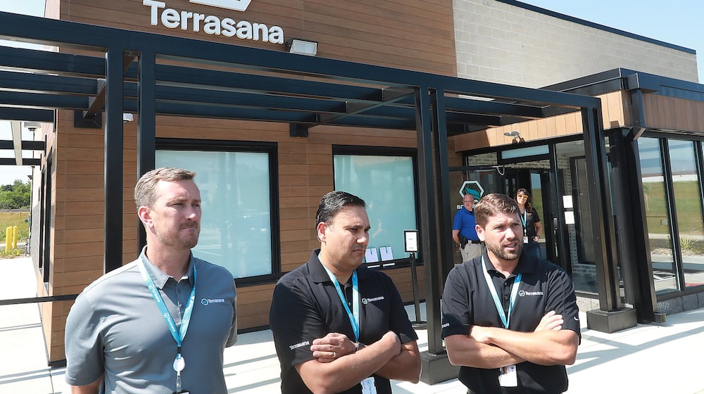 The owners of Terrasana, the new medical marijuana dispenary at 183 Raydo Circle in Springfield, talk about the opening day on Thursday. The owners are, from left, Craig Mauer, Bill Kedia and Todd Yaross. BILL LACKEY/STAFF