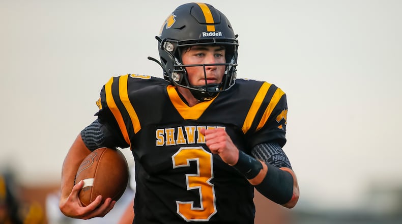 Shawnee High School senior quarterback R.J. Griffin runs the ball during their game against Eaton on Thursday night in Springfield. The Braves won 34-12. Michael Cooper/CONTRIBUTED