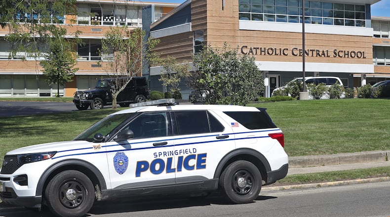A Springfield police cruiser sits in front of Catholic Central School Friday, Sept. 23, 2022, after a false call reporting an active shooter inside the school on East High Street. BILL LACKEY/STAFF