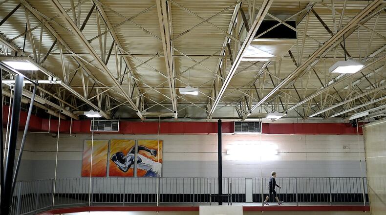 Beverly Hannon walks on the second floor walking track around the Springfield YMCA gymnasium Tuesday. The Springfield Family YMCA board is in the process of reviewing bids for the current facility. They have received bids as high as $450,000 and the money will go towards replacing the roof of the current building. Bill Lackey/Staff