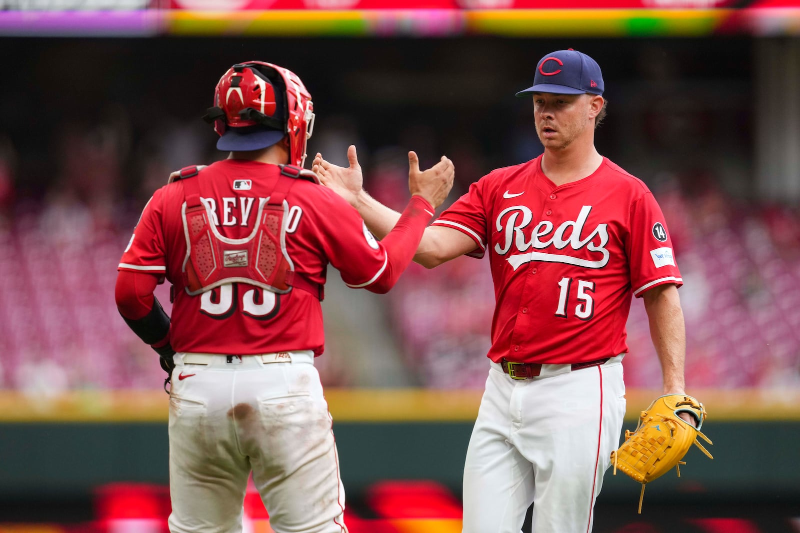 Cincinnati Reds' Emilio Pagán (15) celebrates with Jose Trevino, left, following a baseball game against the Tampa Bay Rays, Sunday, July 27, 2025, in Cincinnati. (AP Photo/Jeff Dean)