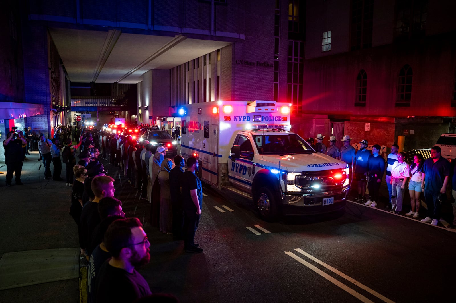 The ambulance carrying the body of Didarul Islam exits NewYork-Presbyterian/Weill Cornell Medical Hospital during the dignified transfer of the slain officer, who was shot and killed by a gunman Monday evening, early Tuesday, July 29, 2025, in New York. (AP Photo/Angelina Katsanis)