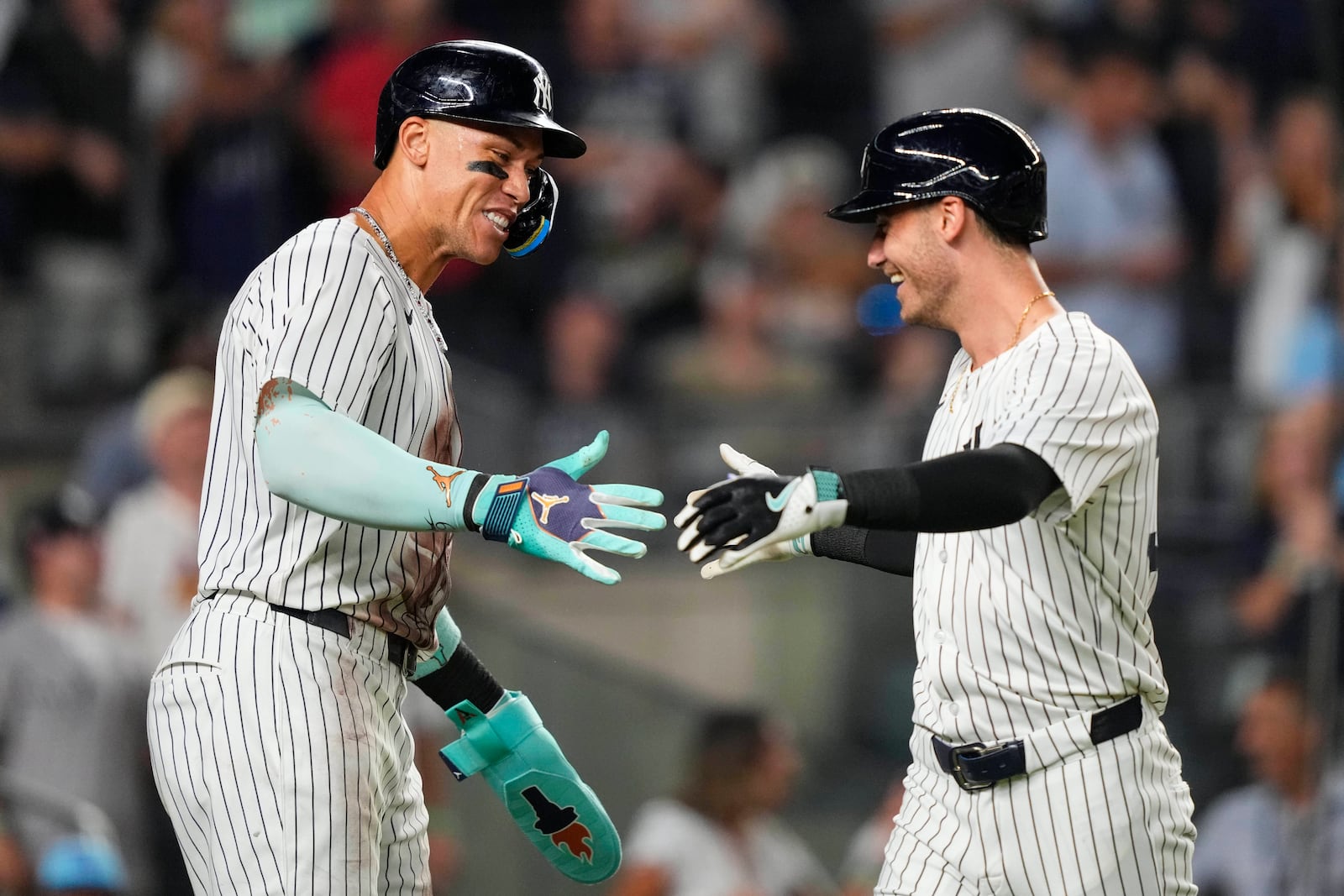 New York Yankees' Cody Bellinger, right, celebrates with Aaron Judge, left, after hitting a home run during the eighth inning of a baseball game against the Chicago Cubs, Friday, July 11, 2025, in New York. (AP Photo/Yuki Iwamura)