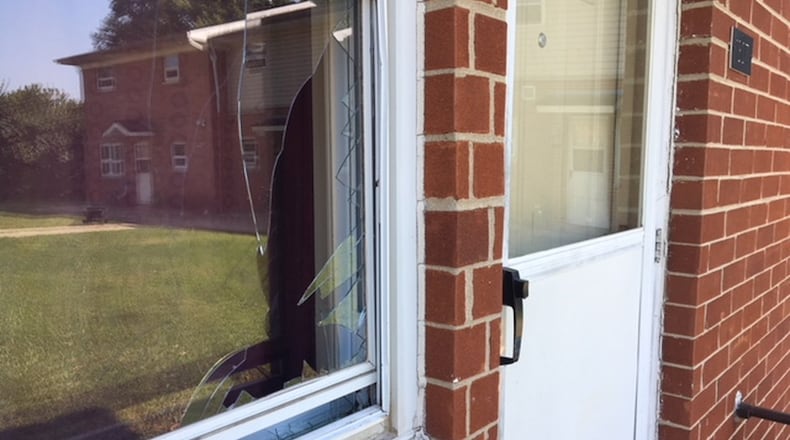 A bullet broke this window’s glass during a shooting on Perry Street in Springfield on Saturday. Springfield Police responded to three separate shootings over the weekend. JENNA LAWSON/STAFF