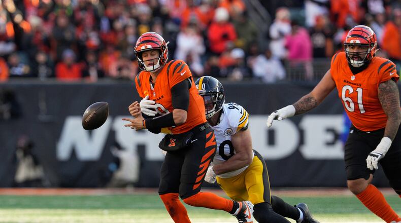 Pittsburgh Steelers linebacker T.J. Watt (90) forces a fumble by Cincinnati Bengals quarterback Joe Burrow, left, during the first half of an NFL football game Sunday, Dec. 1, 2024, in Cincinnati. (AP Photo/Jeff Dean)