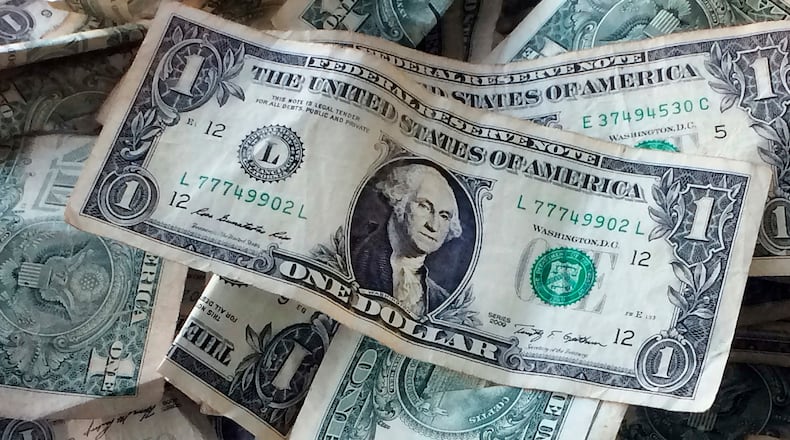 FILE - This Oct. 24, 2016 file photo shows dollar bills in New York. (AP Photo/Mark Lennihan, File)