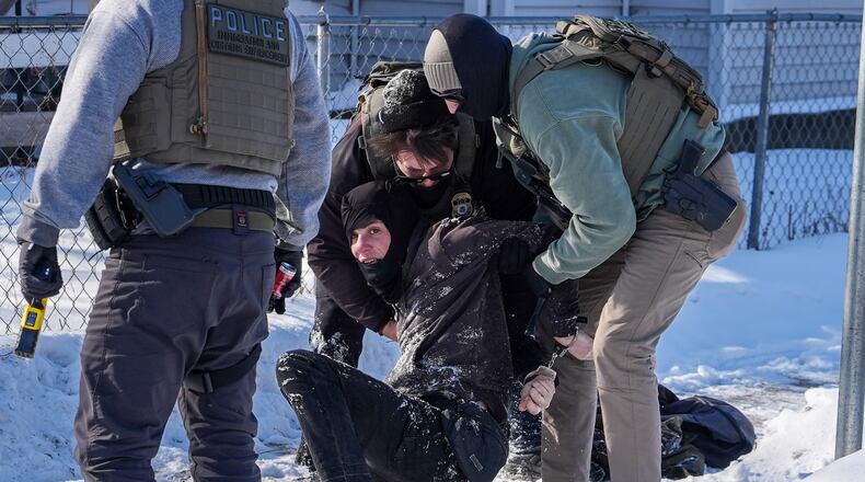 An person is detained by federal agents on Tuesday, Feb. 3, 2026, in Minneapolis. (AP Photo/Ryan Murphy)