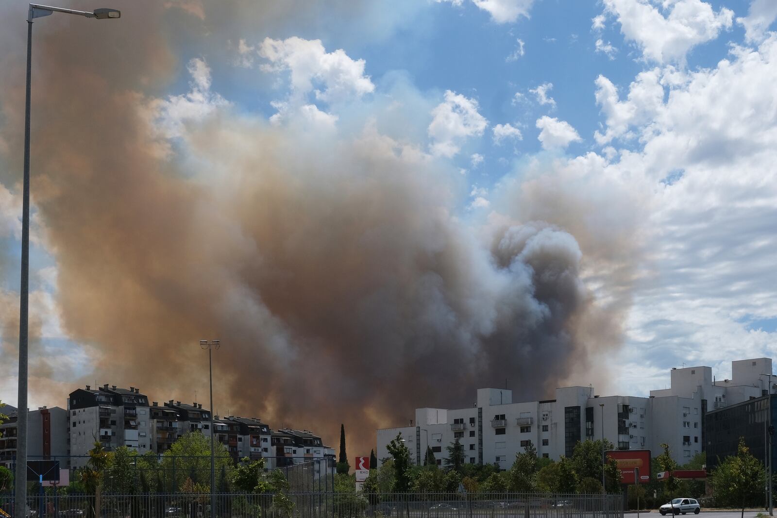 Smoke rises from trees burned by wildfire near Montenegro capital Podgorica, Sunday, July 27, 2025. (AP Photo/Risto Bozovic)