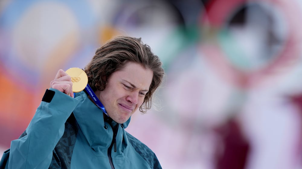 Brazil's Lucas Pinheiro Braathen is overcome by emotion as he holds his gold medal for an alpine ski, men's giant slalom race, at the 2026 Winter Olympics, in Bormio, Italy, Saturday, Feb. 14, 2026.(AP Photo/Julia Demaree Nikhinson)