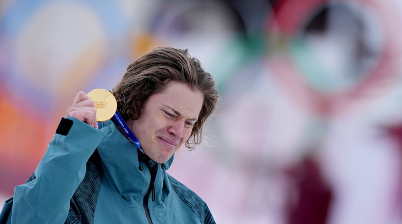 Brazil's Lucas Pinheiro Braathen is overcome by emotion as he holds his gold medal for an alpine ski, men's giant slalom race, at the 2026 Winter Olympics, in Bormio, Italy, Saturday, Feb. 14, 2026.(AP Photo/Julia Demaree Nikhinson)