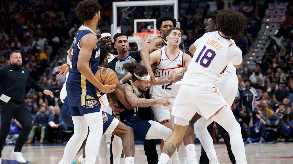 New Orleans Pelicans guard Jose Alvarado (15) and Phoenix Suns center Mark Williams get into a scrum during the third quarter before both were ejected during an NBA basketball game in New Orleans, Saturday, Dec. 27, 2025. (AP Photo/Matthew Hinton)
