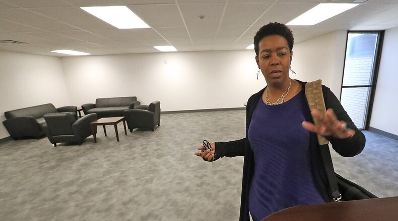 Wendy Doolittle, CEO of McKinley Hall, talks about the commons area for the men’s residential section of the new McKinley Hall location Monday. Bill Lackey/Staff