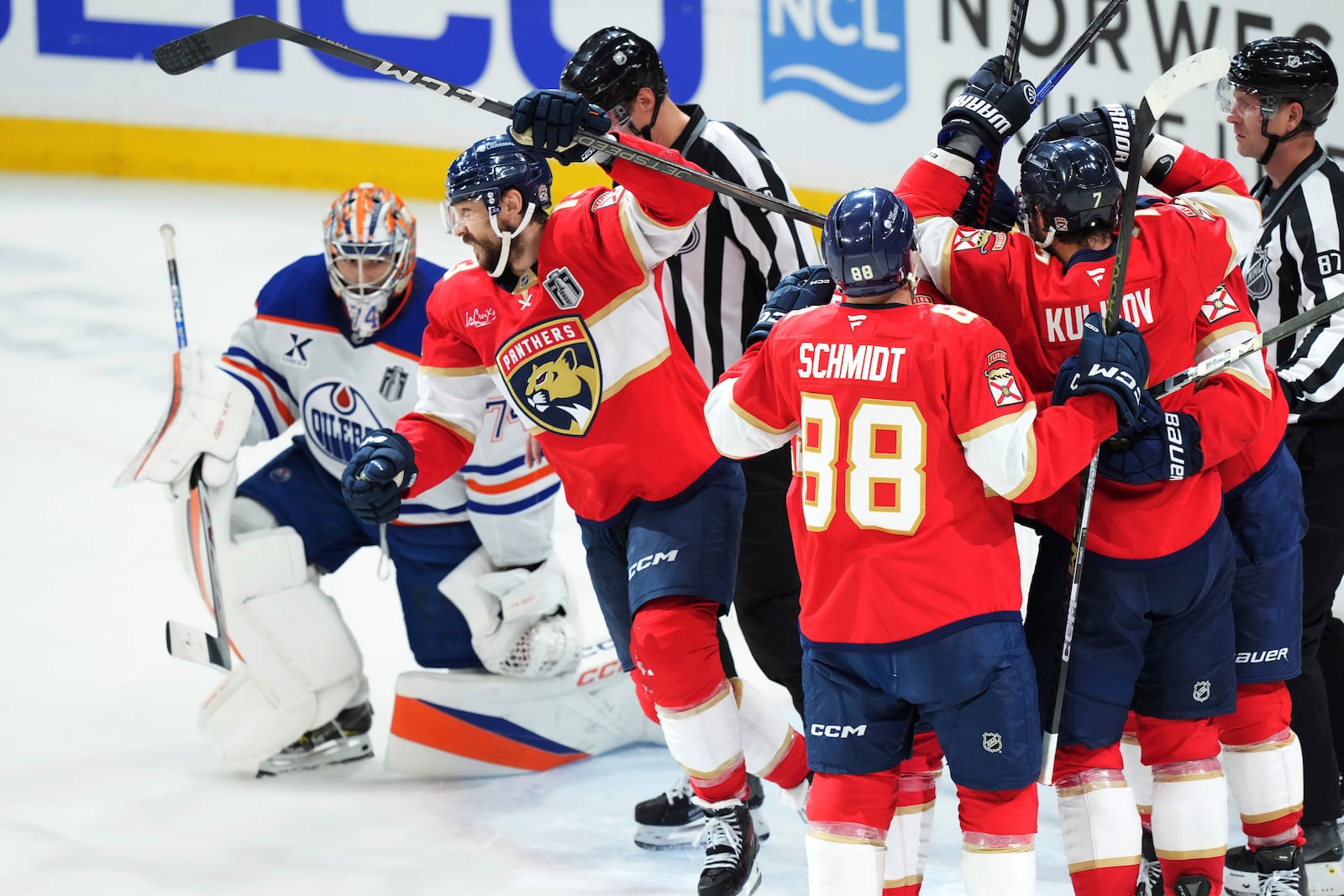 Florida Panthers' Sam Reinhart, second left, celebrates his goal against Edmonton Oilers goalie Stuart Skinner (74) with teammates during the second period in Game 6 of the NHL hockey Stanley Cup Final in Sunrise, Fla., Tuesday, June 17, 2025. (Nathan Denette/The Canadian Press via AP)