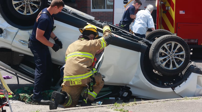 Three people were transported with non life-threatening injuries after a two-car accident at the intersection of West Main Street and North Lowry Avenue Friday, June 2, 2023. One of the cars flipped over and two passengers had to be rescued. BILL LACKEY/STAFF