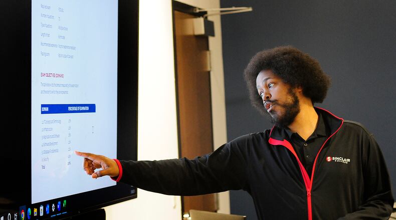 Sinclair Community College instructor, Liban Knight, teaches an Information Technology class Wednesday, Jan. 24, 2024 at the Montgomery County Westown Employment Opportunity Center. MARSHALL GORBY\STAFF
