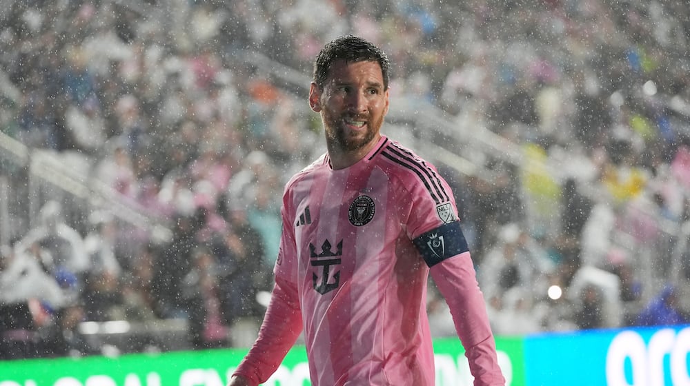 Inter Miami forward Lionel Messi (10) walks to kick a corner kick in heavy rain during the first half of a CONCACAF Champions Cup Round of 16 soccer match against Nashville, Wednesday, March 18, 2026, in Fort Lauderdale, Fla. (AP Photo/Marta Lavandier)