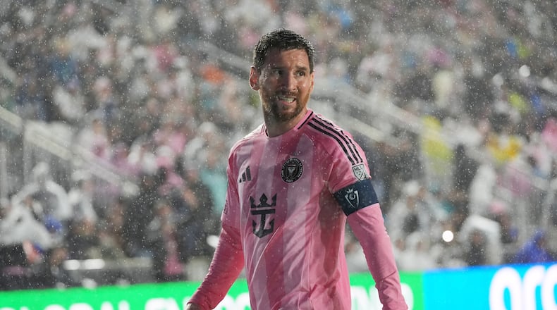 Inter Miami forward Lionel Messi (10) walks to kick a corner kick in heavy rain during the first half of a CONCACAF Champions Cup Round of 16 soccer match against Nashville, Wednesday, March 18, 2026, in Fort Lauderdale, Fla. (AP Photo/Marta Lavandier)